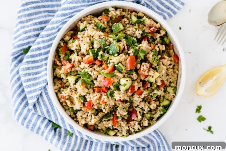 A colorful bowl of Copycat Costco Quinoa Salad with chickpeas, lentils, and fresh vegetables.