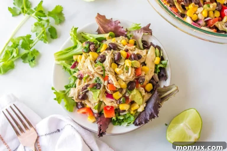 A vibrant bowl of Southwest Chicken Salad with shredded chicken, black beans, corn, and avocado.