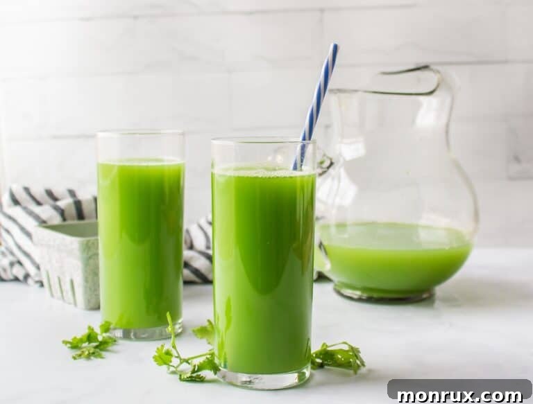 Fresh cilantro juice in a glass with a straw, garnished with cilantro sprigs.