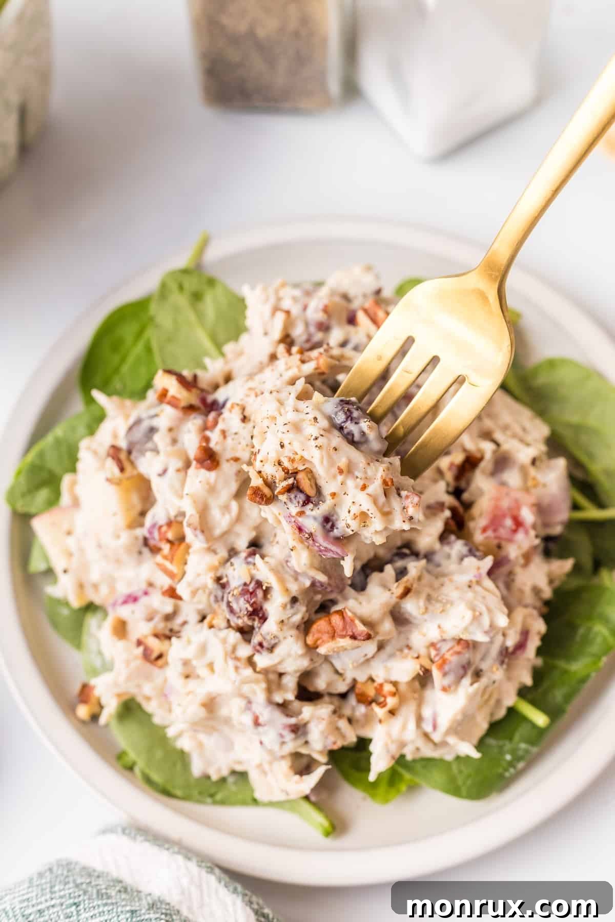 A fork taking a bite of creamy Apple Pecan Chicken Salad.