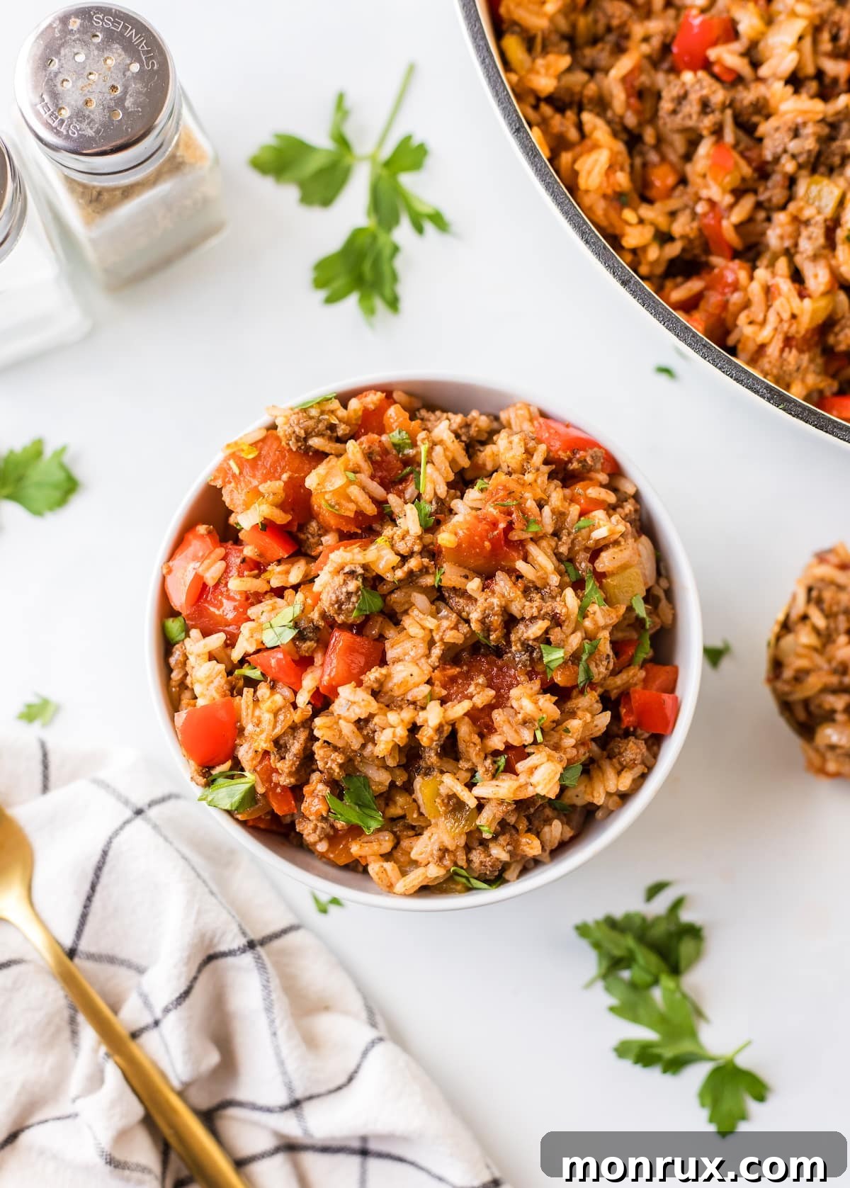 A close-up of a serving of Unstuffed Pepper Skillet in a rustic bowl, garnished with fresh herbs, ready to be enjoyed.