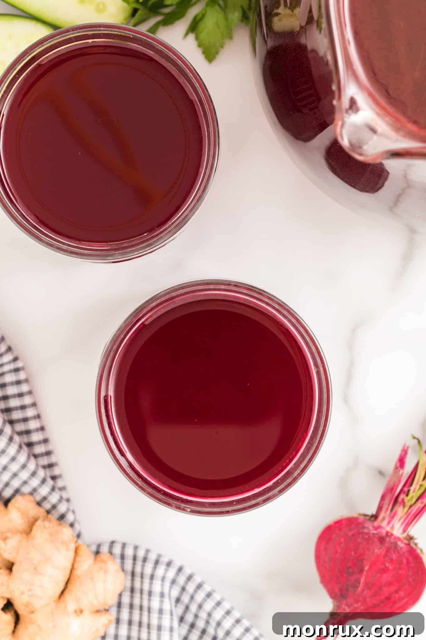 Two elegant glasses of refreshing beet ginger juice.
