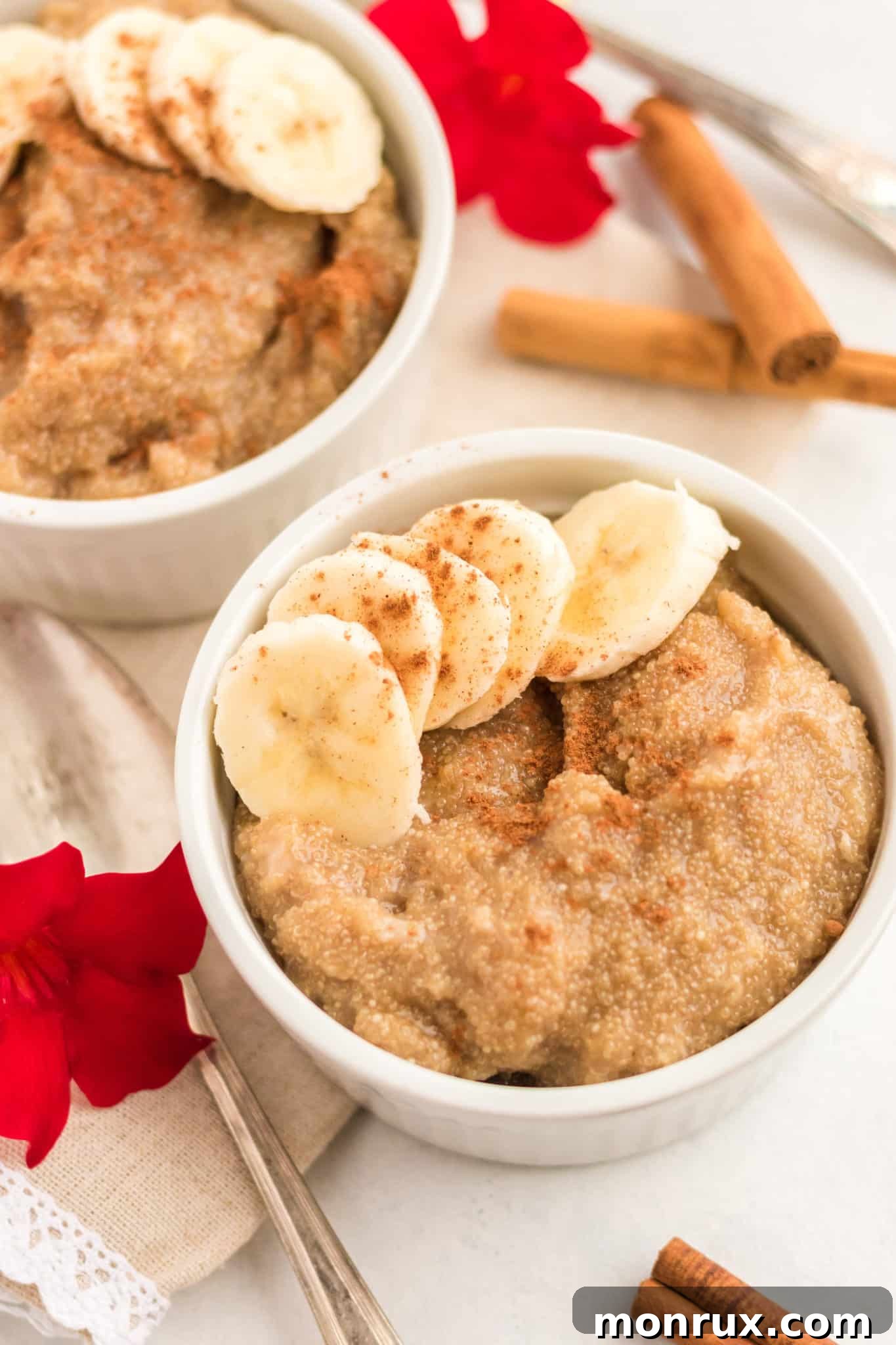 Two bowls of creamy amaranth porridge generously topped with golden sliced bananas, ready to be enjoyed.