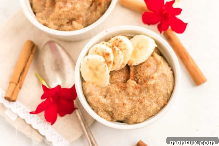 A beautifully presented bowl of creamy amaranth porridge, adorned with freshly sliced bananas and a delicate sprinkle of cinnamon.